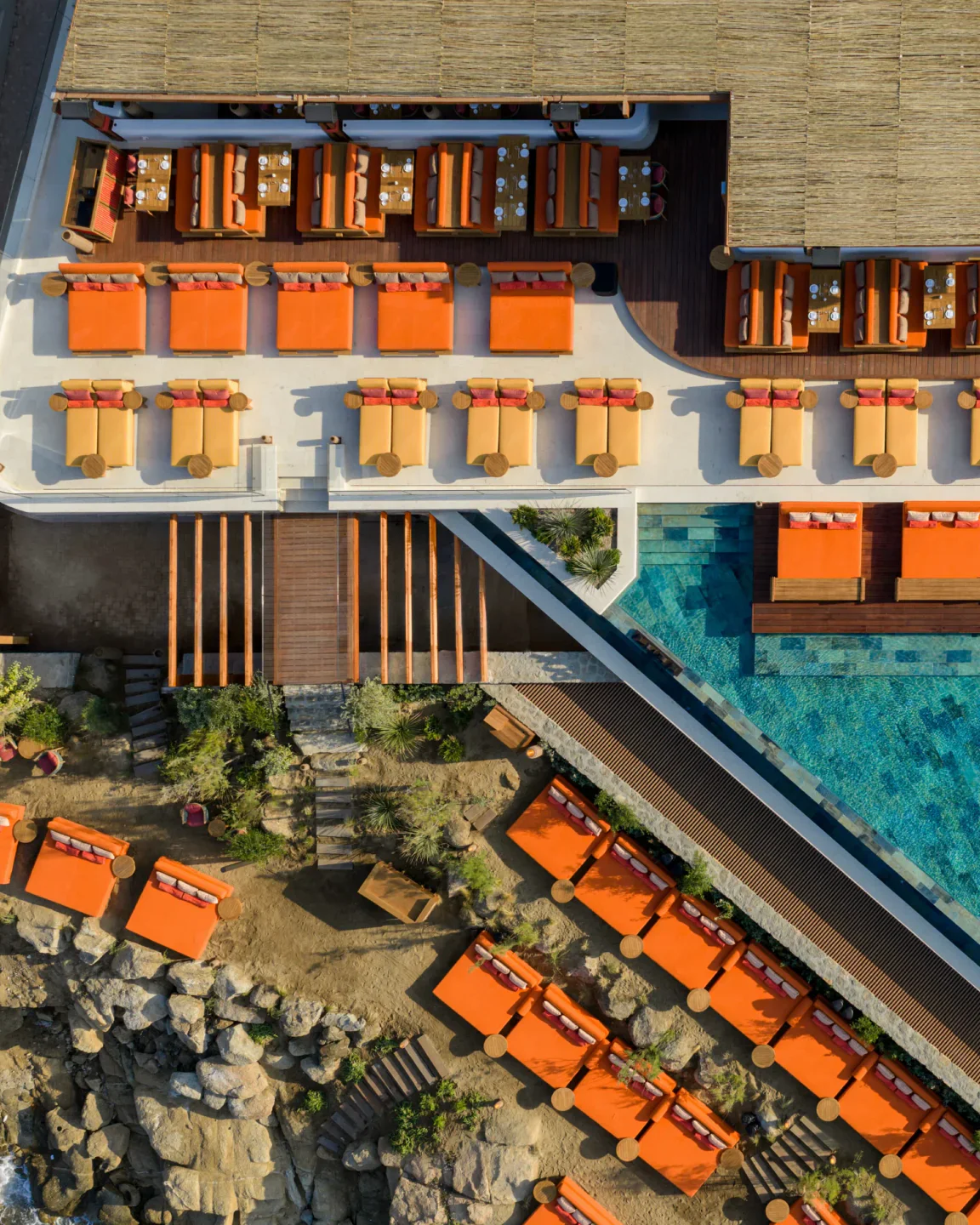 ROKA Santorini restaurant exterior with orange lounge seating and poolside cabanas