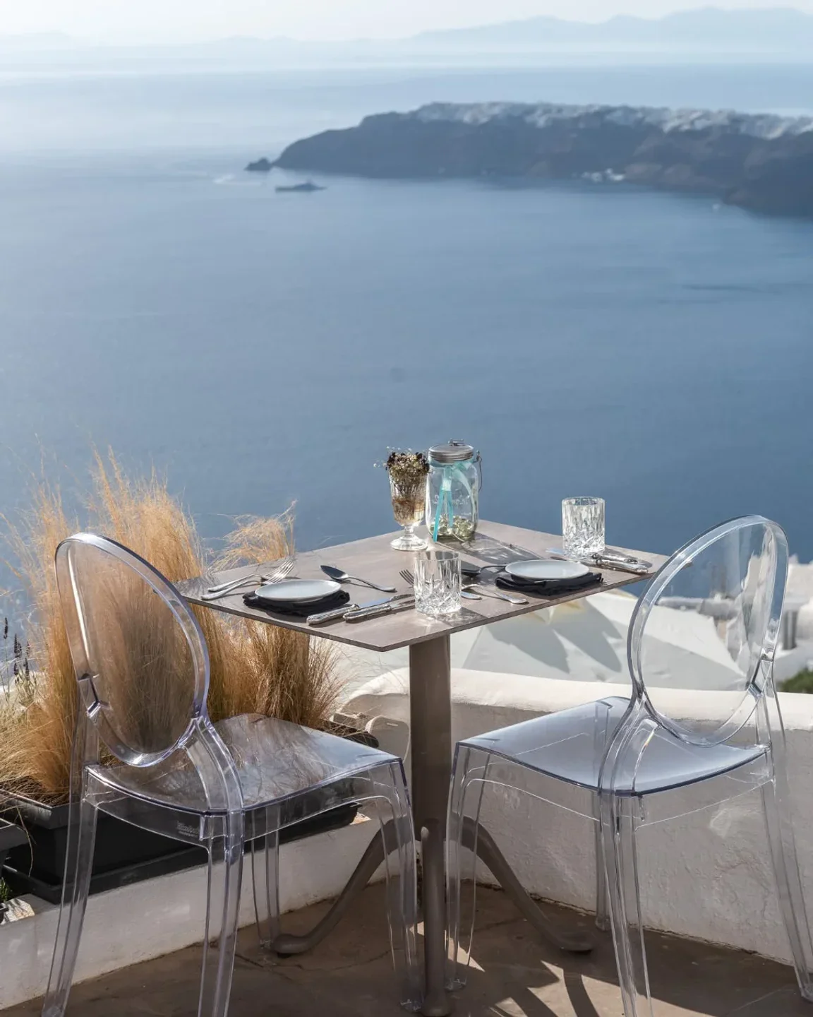 The Athenian House restaurant's outdoor seating with a stunning ocean view, ideal for a romantic dinner.
